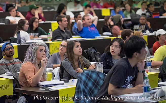 students sitting at desks listening to a lecture