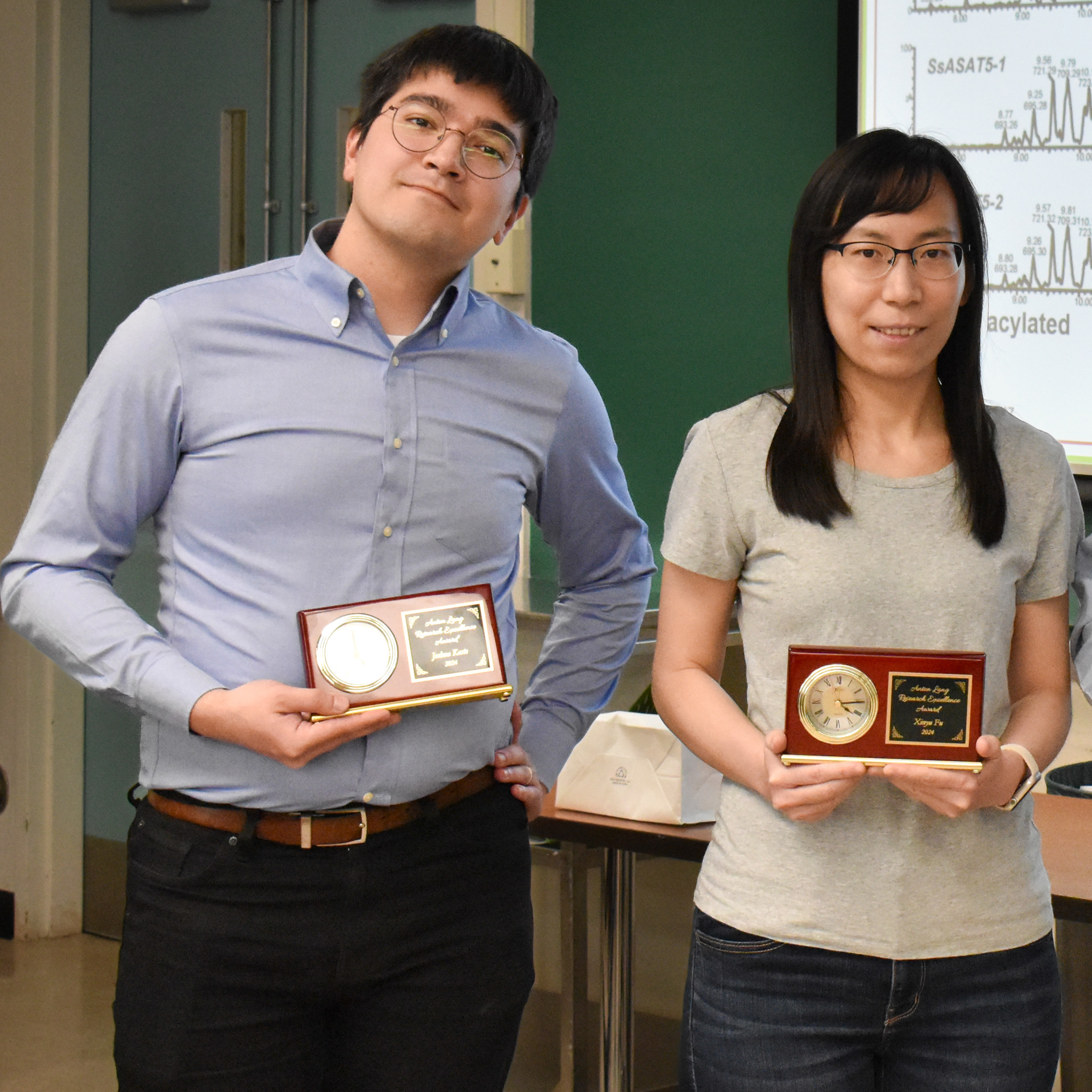 Joshua Kaste and Xinyu Fu, holding their awards.